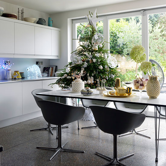 dining room with dining table and accent chairs with christmas tree
