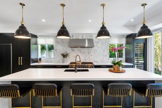 A kitchen with black painted cabinets