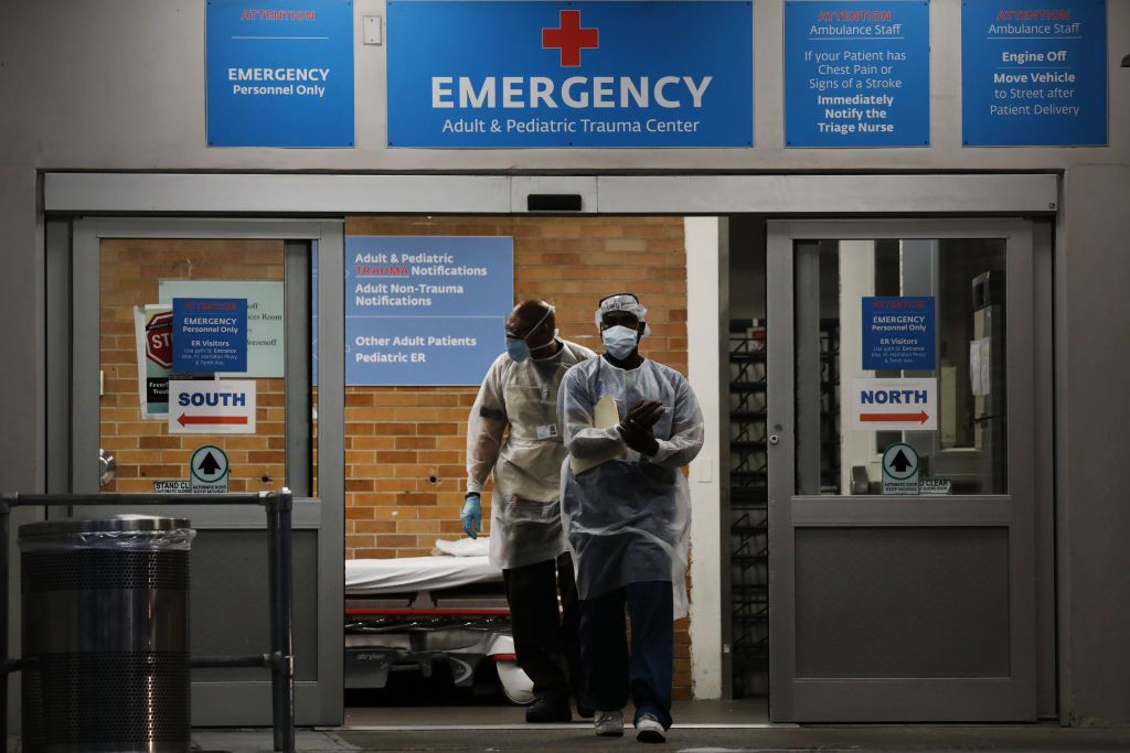 Medical workers walk outside a special coronavirus area at Maimonides Medical Center on May 26, 2020