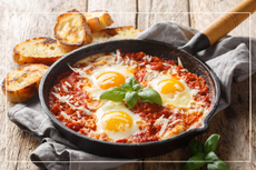 Shakshuka in a cast iron pan with bread