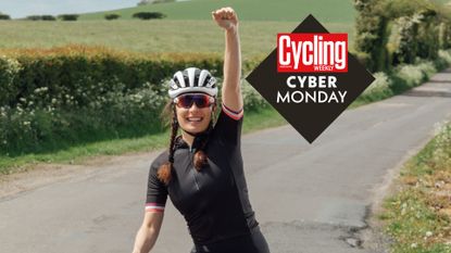 A feamle cyclist punches the air in celebration of cyber monday