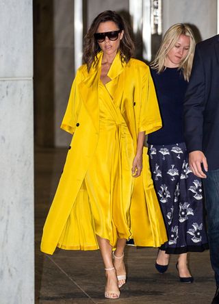 Victoria Beckham in a layered yellow outfit