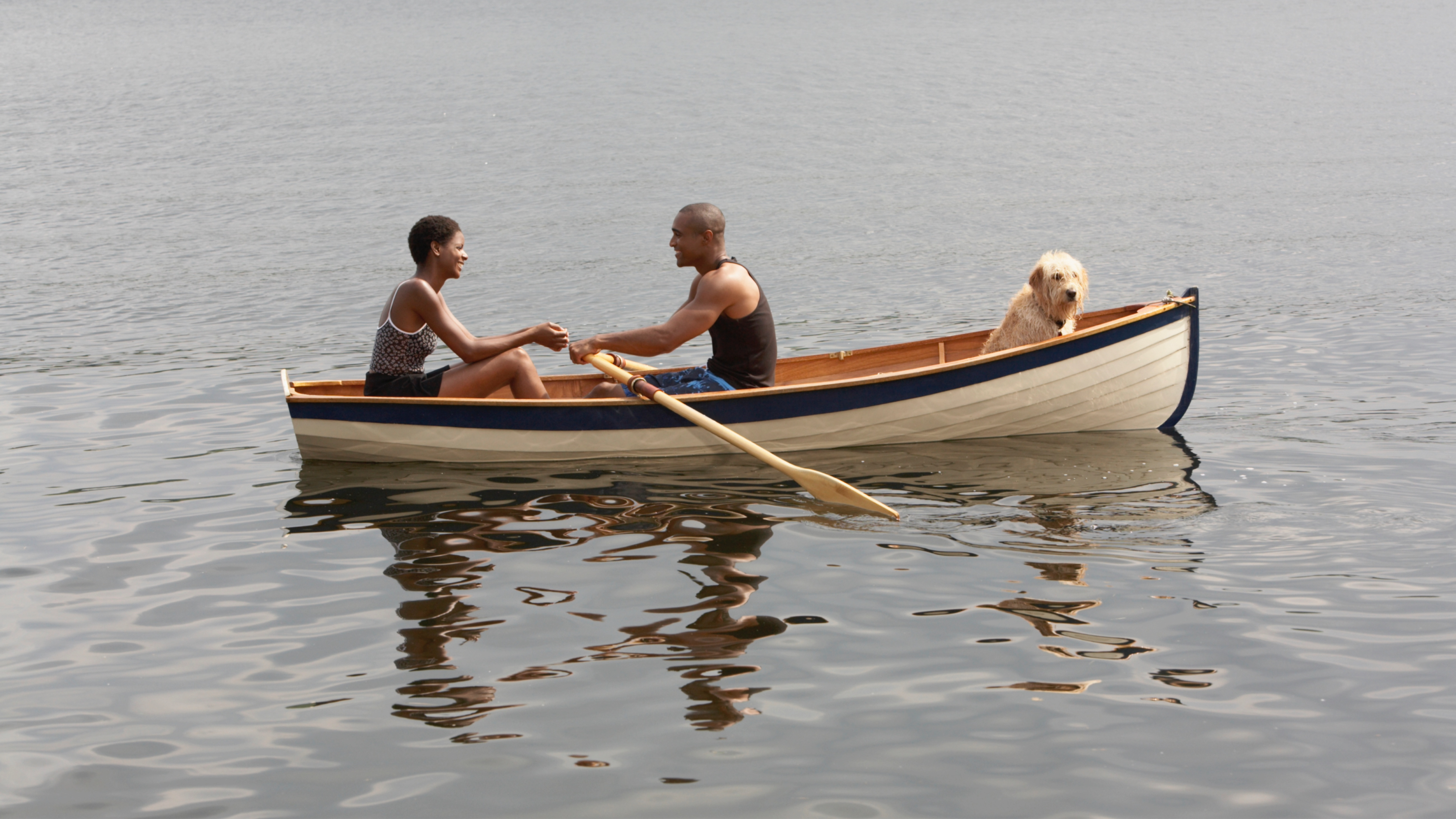 Couple in boat with dog