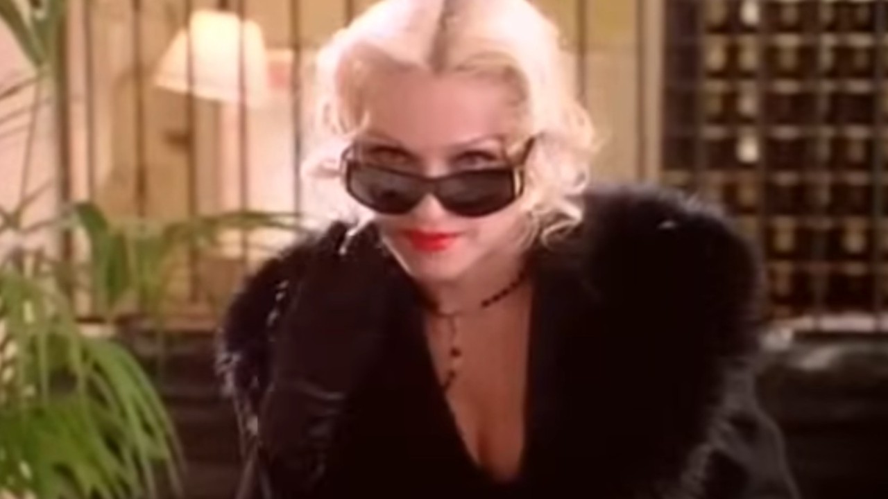 Madonna lowering sunglasses in Four Rooms