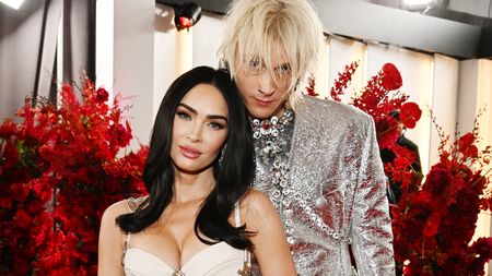 Megan Fox and Machine Gun Kelly in silver and white on the red carpet before their breakup. 