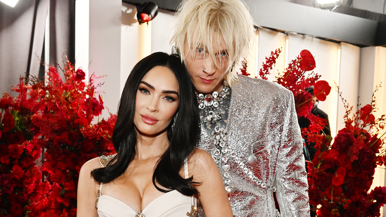 Megan Fox and Machine Gun Kelly in silver and white on the red carpet before their breakup. 
