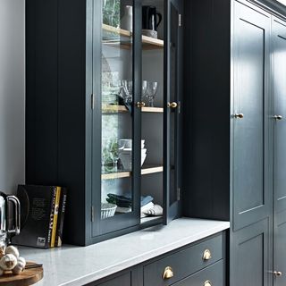 kitchen with black cabinet and white marble countertop