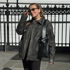 @rebeccarhysevans wearing a leather jacket outfit.