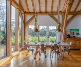 inside of oak frame extension with glazed walls and vaulted ceiling