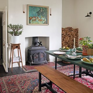 log burner in dining room with patterned rug