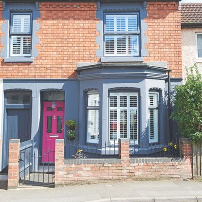 Bright pink front door on renovated Victorian house