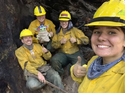 Firefighters pose with Baby Yoda.