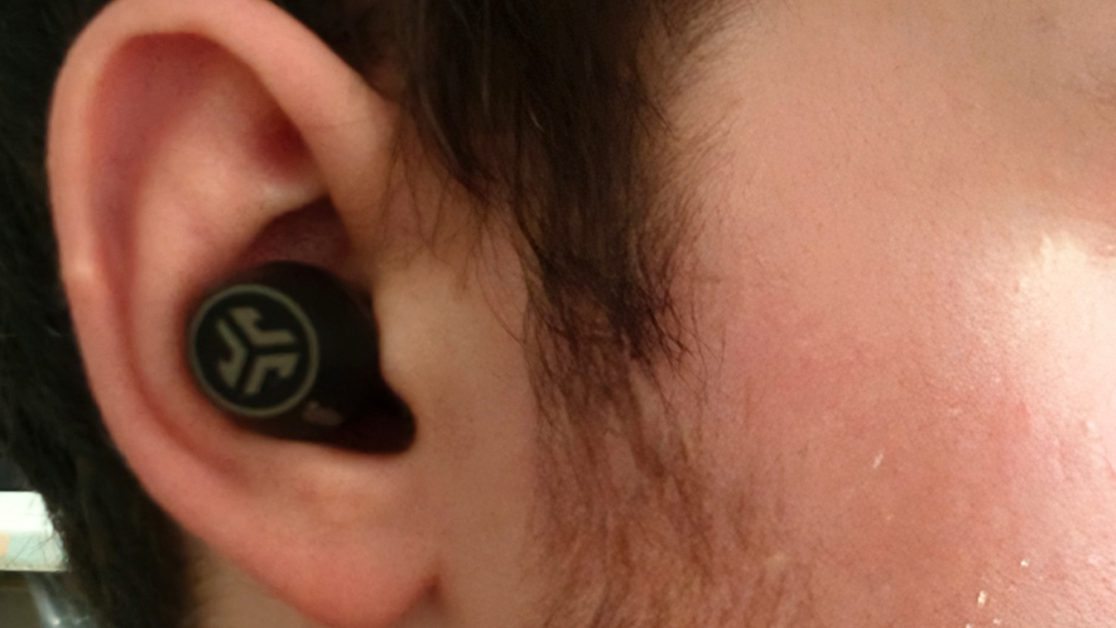 The JLab Epic Lab Edition earbuds in an ear.