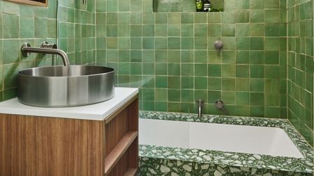 green zellige tiles in a bathroom with terrazzo and a chrome sink