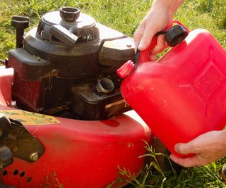 Filling up a lawn mower with gas