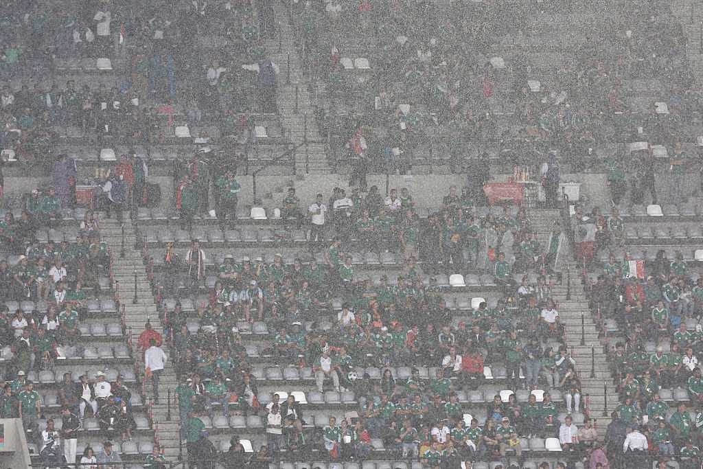 Mexican fans take shelter from the rain ahead of the 2026 World Cup round of 16 football match against England