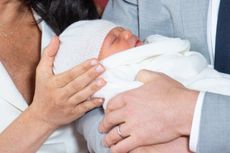 HRH Prince Harry, Duke of Sussex, and his wife Meghan, Duchess of Sussex, pose for a photo with their newborn baby son in St George's Hall at Windsor Castle on May 8, 2019. (Photo by Dominic Lipinski / AFP /Getty Images)