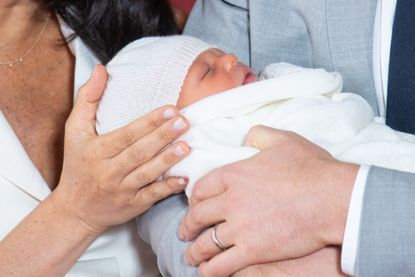 HRH Prince Harry, Duke of Sussex, and his wife Meghan, Duchess of Sussex, pose for a photo with their newborn baby son in St George's Hall at Windsor Castle on May 8, 2019. (Photo by Dominic Lipinski / AFP /Getty Images)