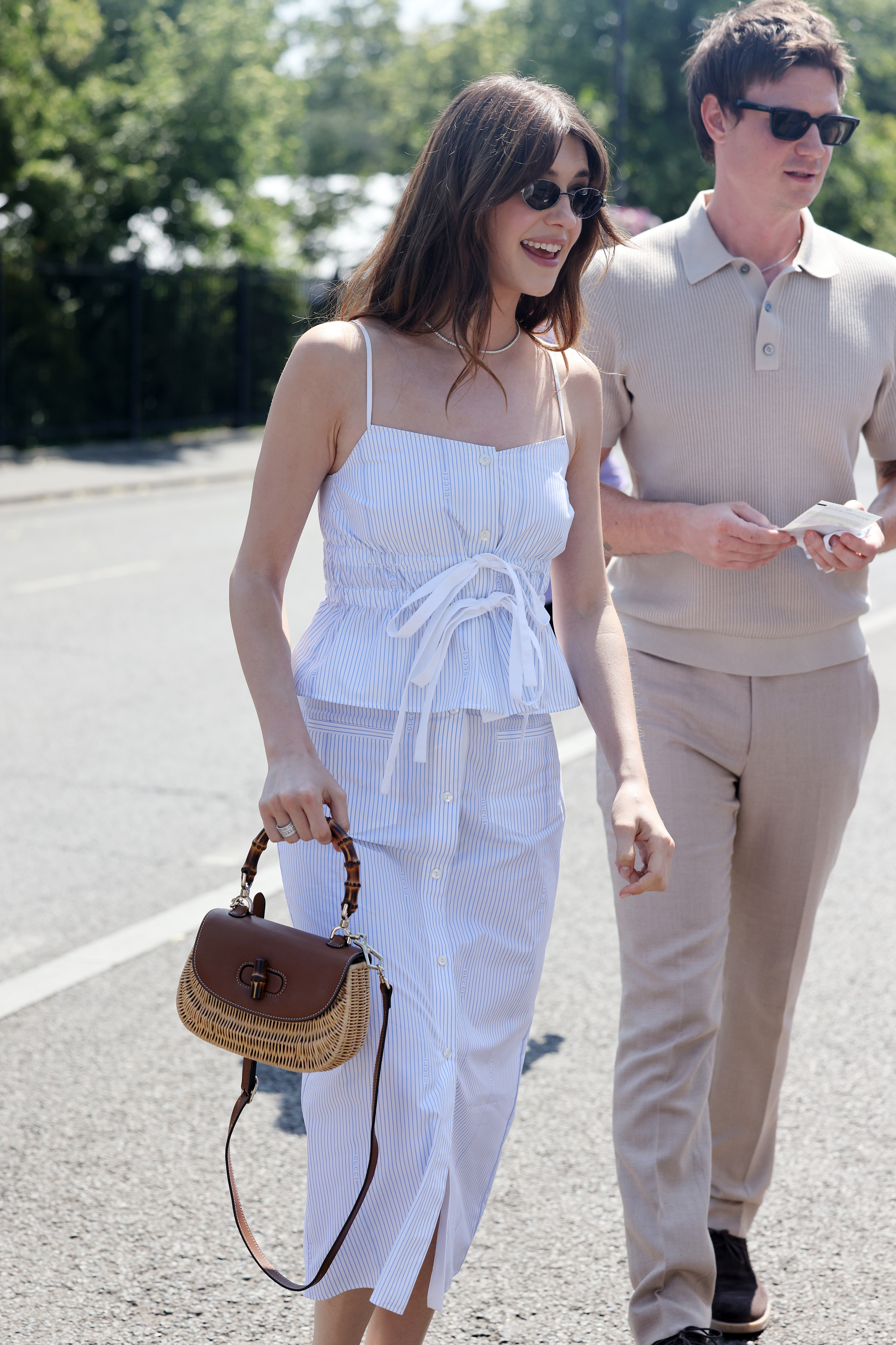 Daisy Edgar wears a matching linen set and carries a Gucci straw bag at Wimbledon