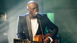 Singer-songwriter Seal playing acoustic guitar