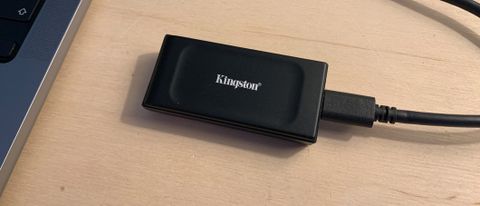 Kingston XS1000 SSD on a wooden desk