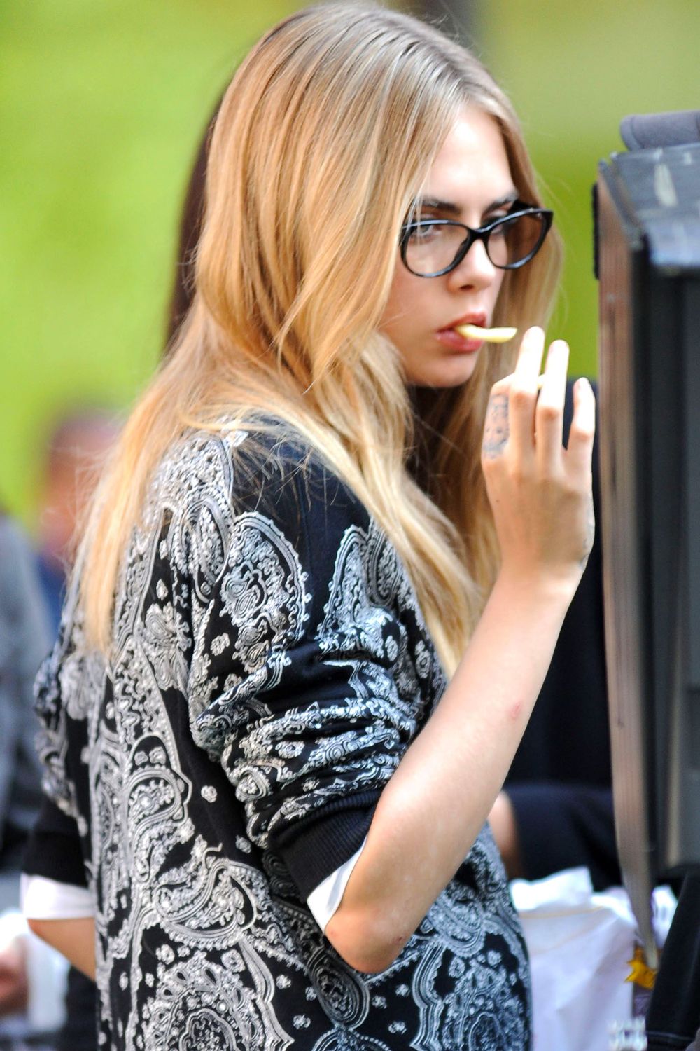 Cara Delevingne eating