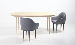 Beech dining table with two grey tub chairs