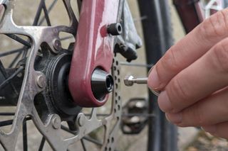 HexLox anti-thef system being fitted to a bike's thru-axle