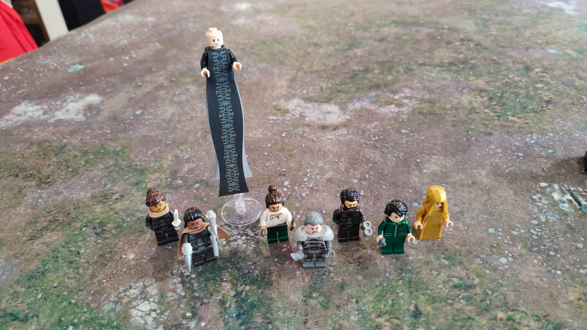 Lego Dune minifigures lined up on a grassy mat