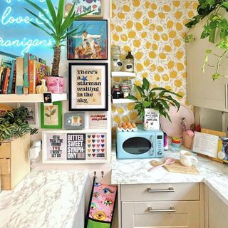 Kitchen renovation with lemon print wallpaper and a pastel blue microwave