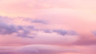 pink sky with clouds to represent neptune retrograde 2022