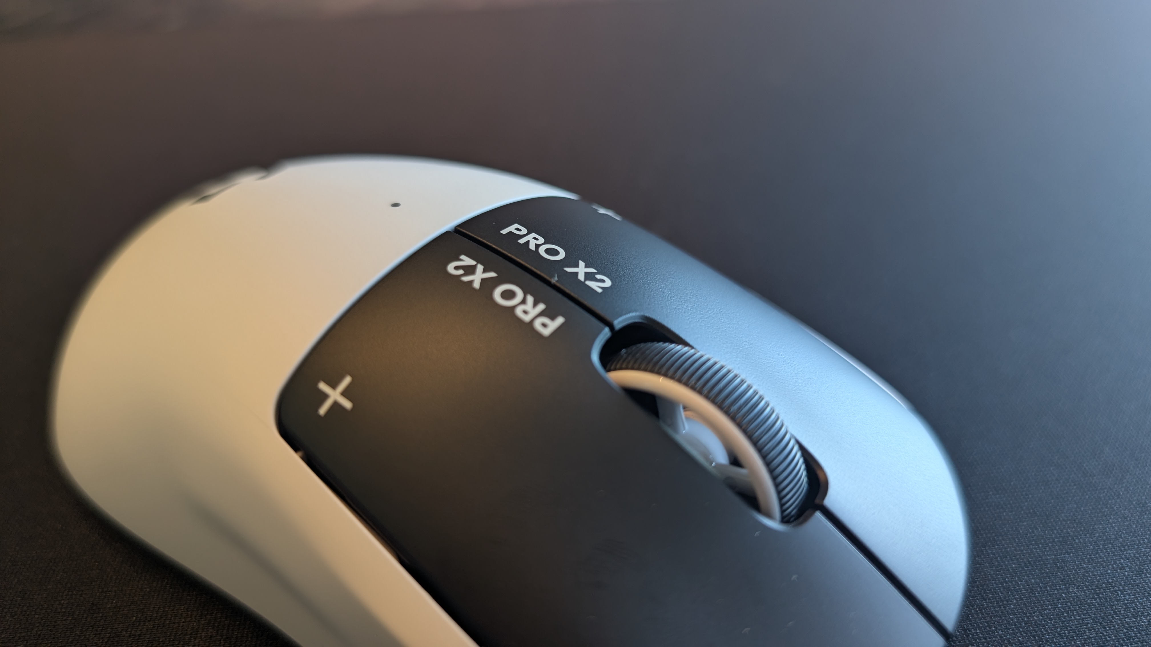 The Logitech G Pro X2 Superstrike pictured on a black mouse mat.