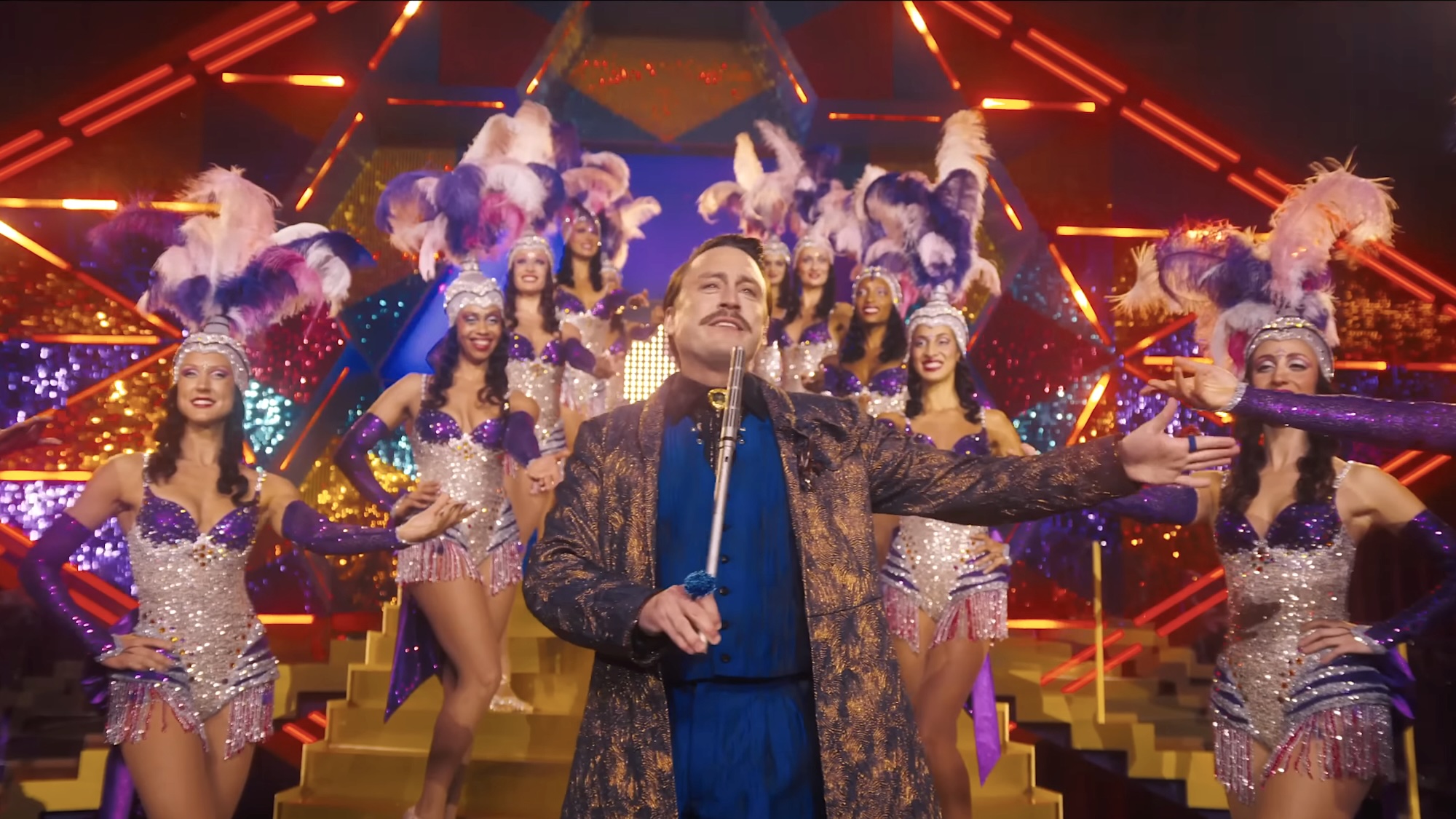 Young Caesar Flickerman hosting Hunger Games in Sunrise on the Reaping