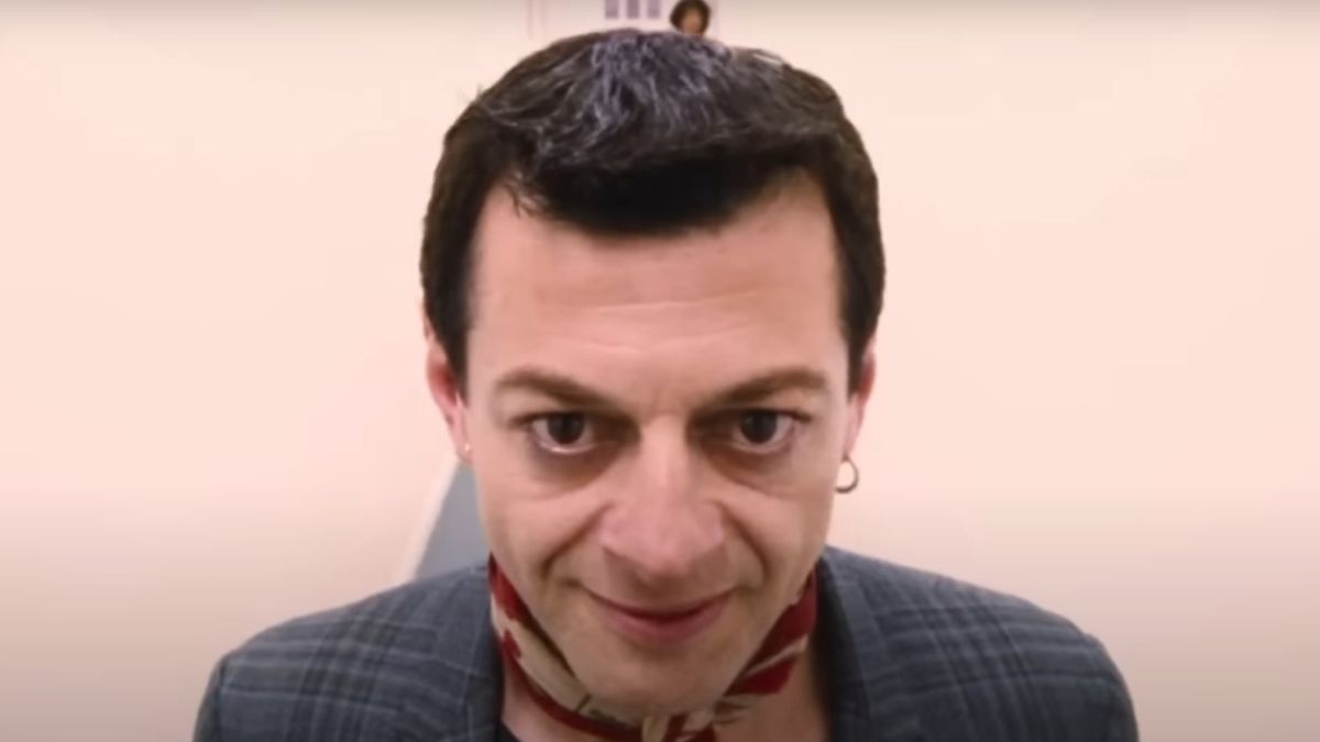 Andy Serkis walks down a white hallway with a menacing smile in Sex &amp; Drugs &amp; Rock &amp; Roll.