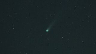 a green fuzzy streak in the night sky