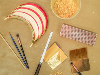 Red and gold speaker parts and tools and gold leaf for gilding