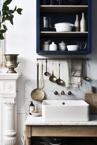 a Neptune Suffolk kitchen with hanging storage and a belfast sink