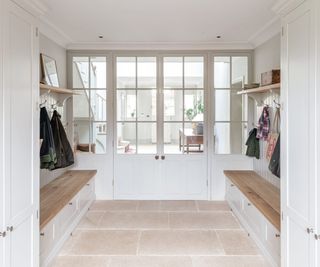 boot room in neutral colours with glass double doors at end into rest of house