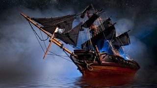A photo of a model pirate ship at night in fog.