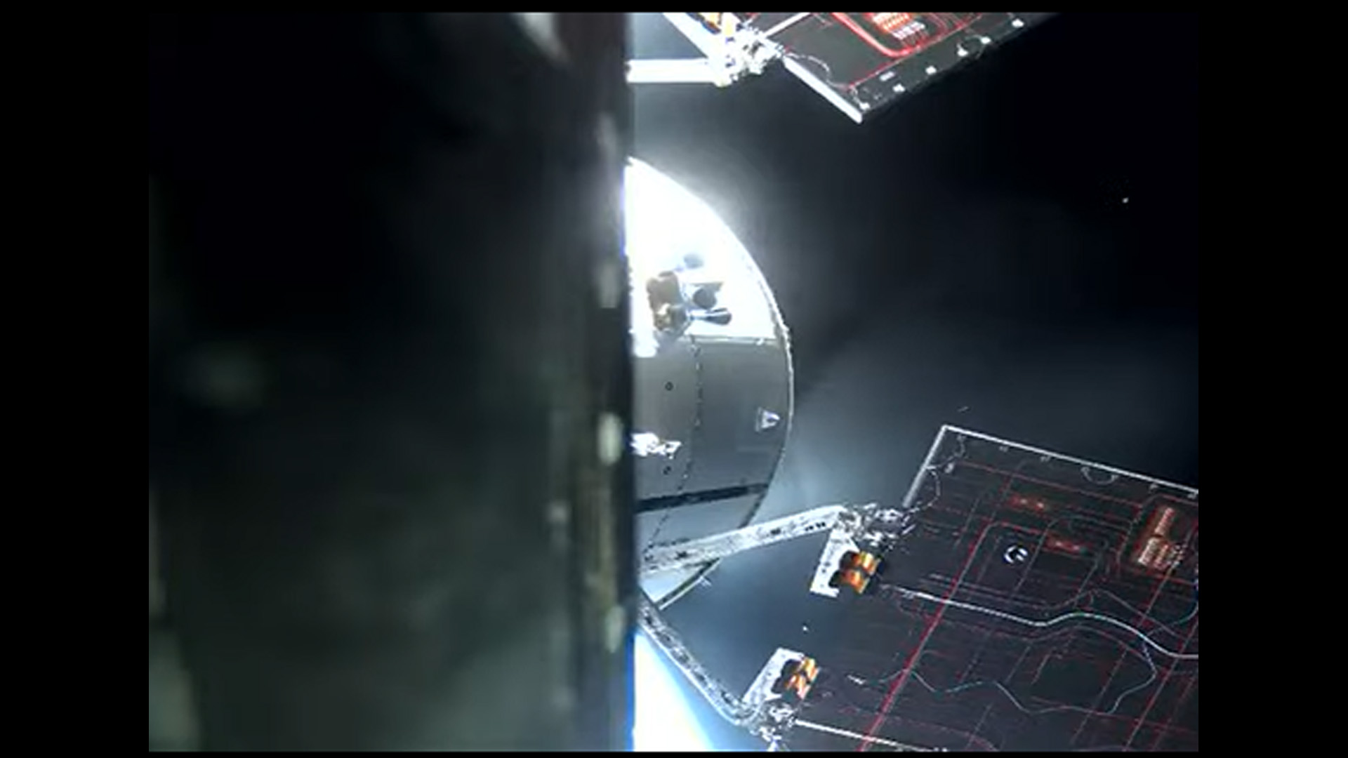 view of a part of orion spacecraft with the curve of the earth and a solar panel
