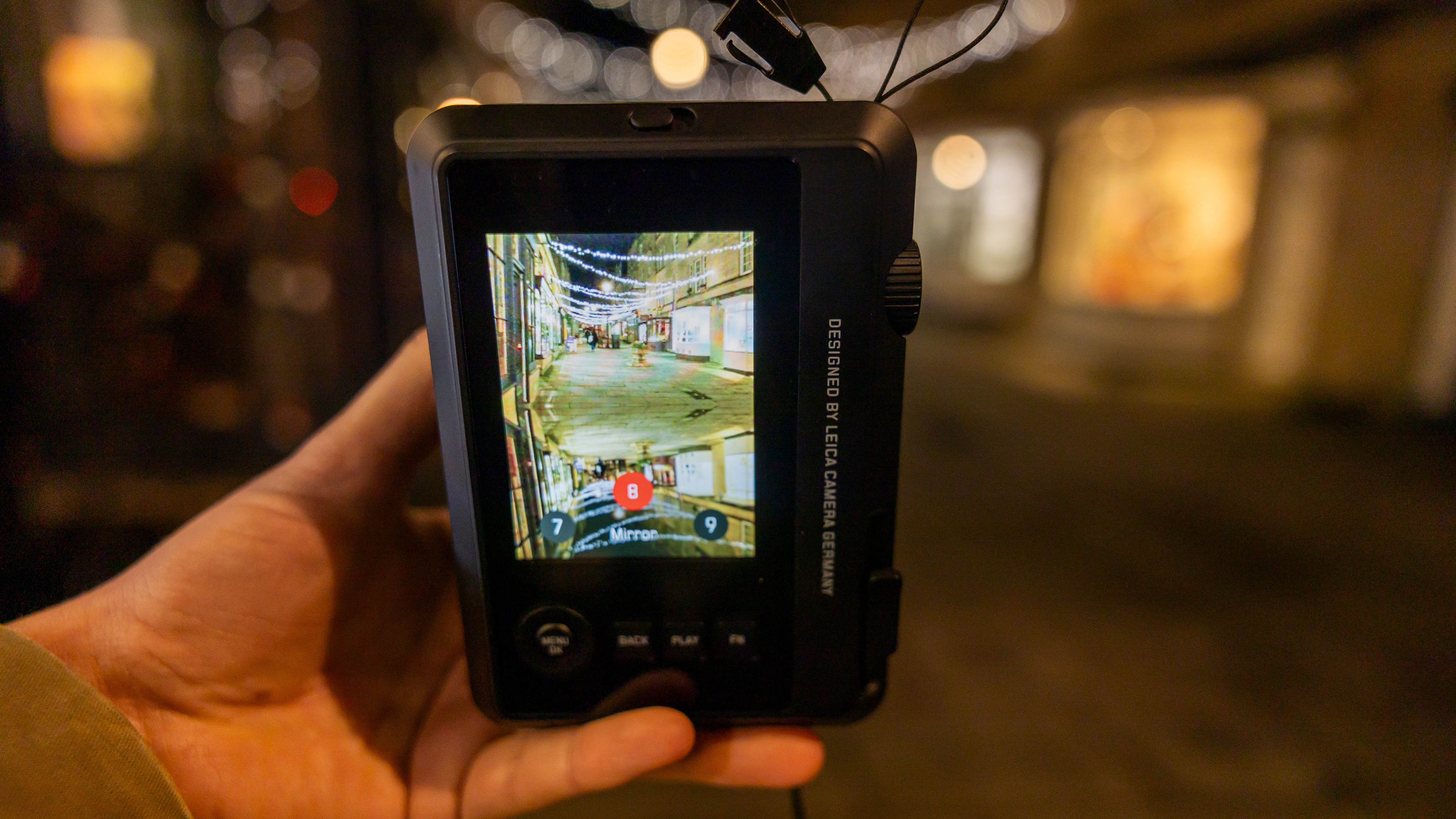 The Leica Sofort 2 screen against a dark nighttime background