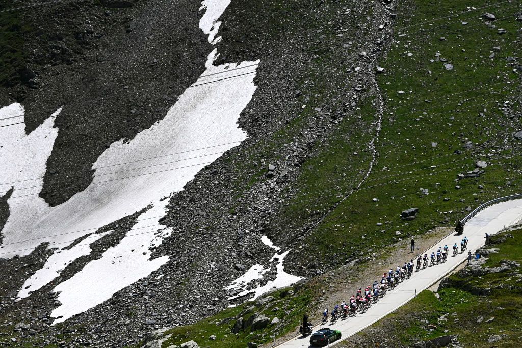 MOOSALP SWITZERLAND JUNE 17 A general view of the peloton passing through Nufenenpass 2478m during the 85th Tour de Suisse 2022 Stage 6 a 1775km stage from Locarno to Moosalp 2048m ourdesuisse2022 WorldTour on June 17 2022 in Moosalp Switzerland Photo by Tim de WaeleGetty Images