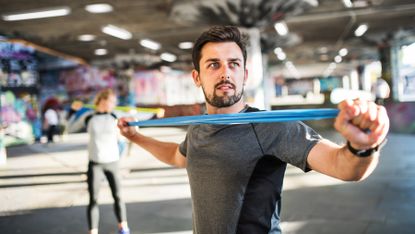 Man working out his arms using a resistance band