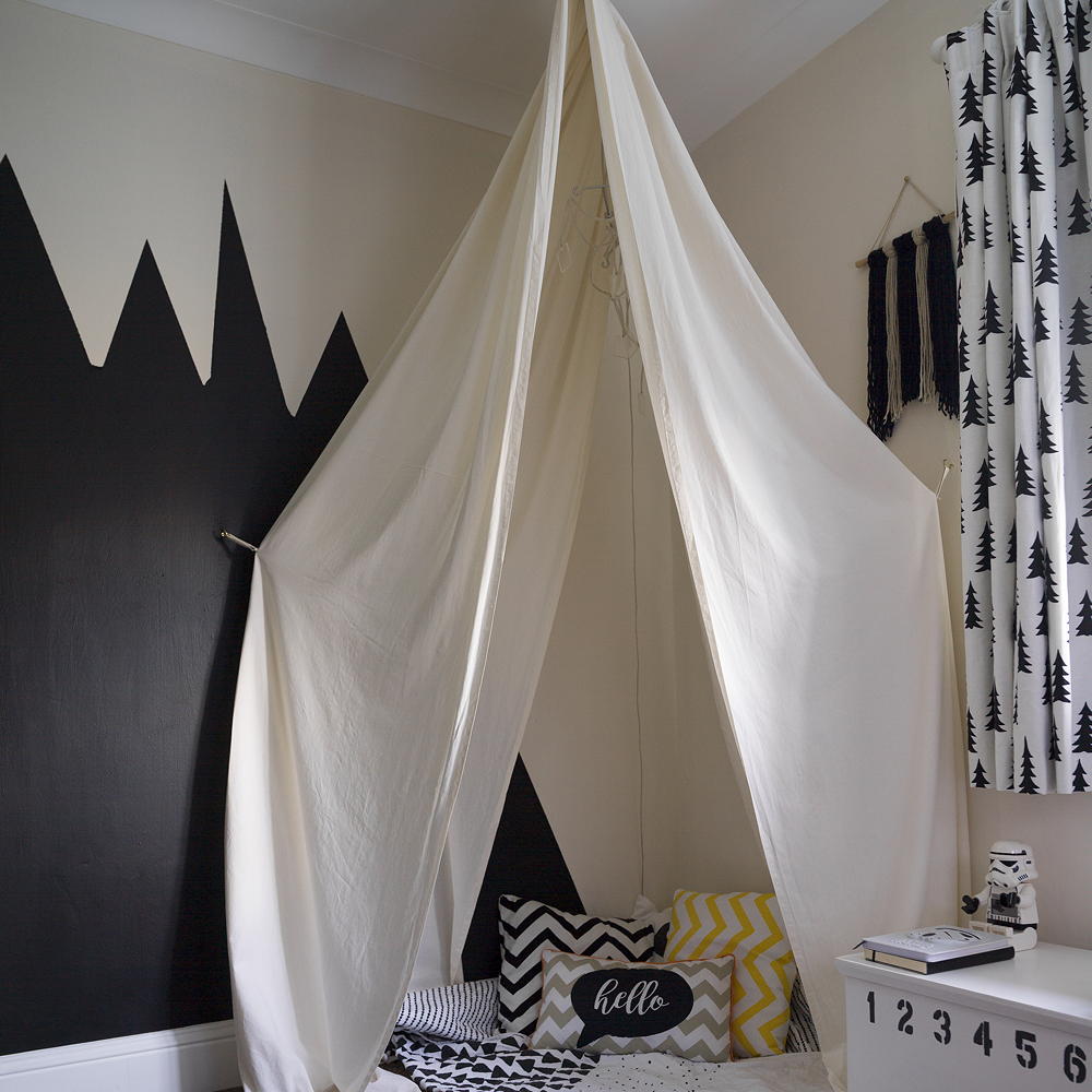 monochrome kids room with white canopy in corner
