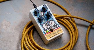 EarthQuaker Devices Rancho de la Luna Dirt Transmitter Fuzz Driver photographed on top of a tweed yellow guitar cable.