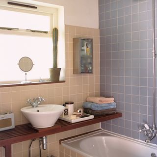 bathroom with blue wall tiles and washbasin
