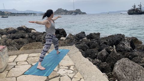 Julia Clarke doing yoga by the sea