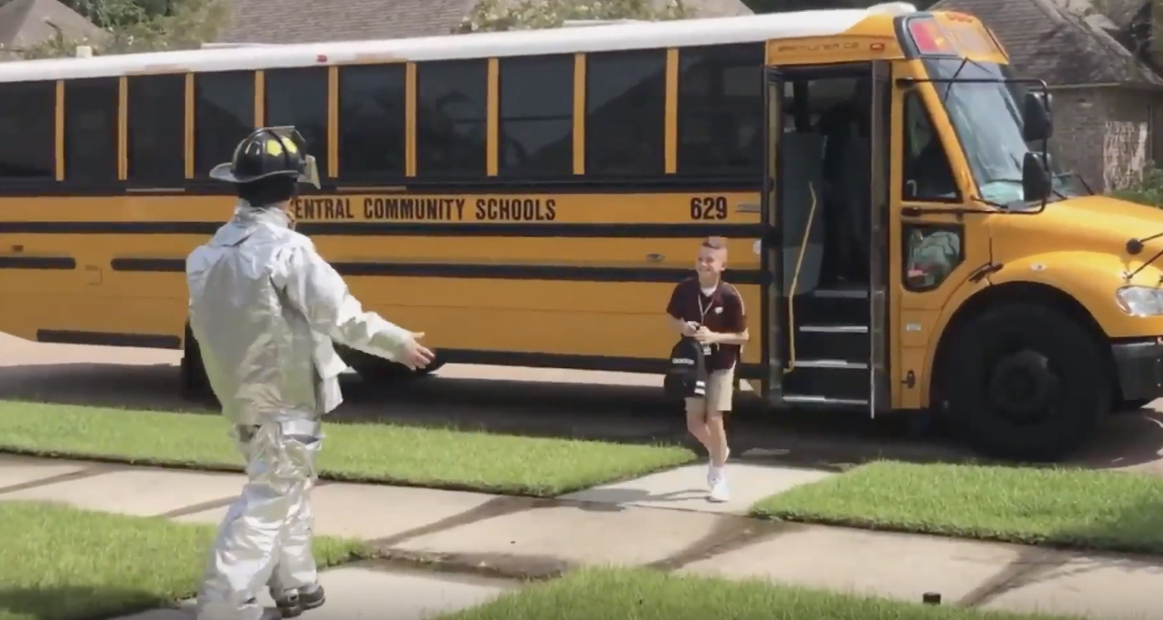 Noah Tingle greets his brother Max while wearing an astronaut costume.