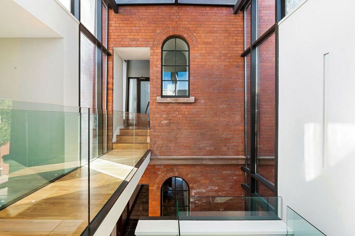 The old brick work now links to a glass extension highlighting the difference between the old and new