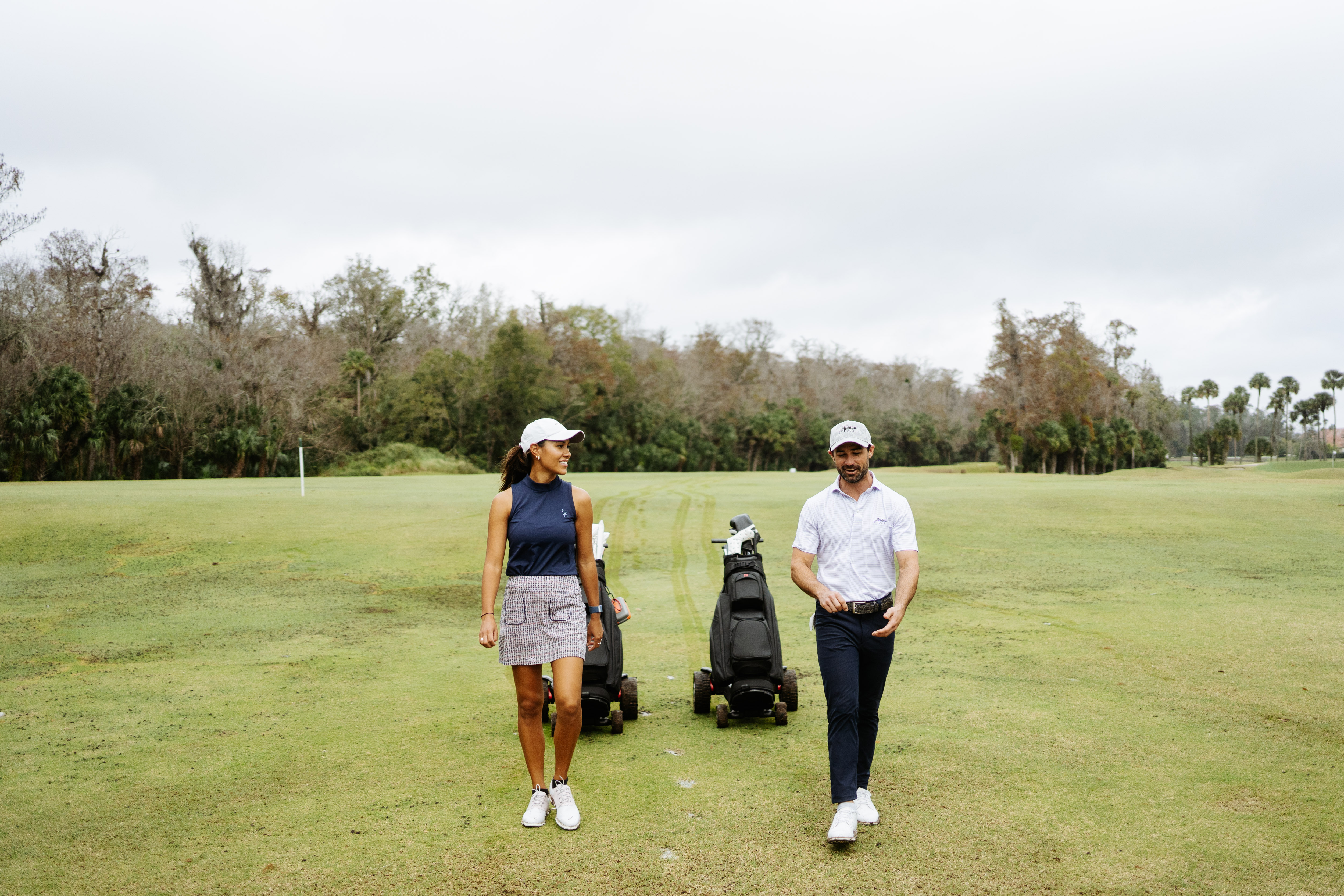 Stewart Golf Q Follow trolley with two golfers